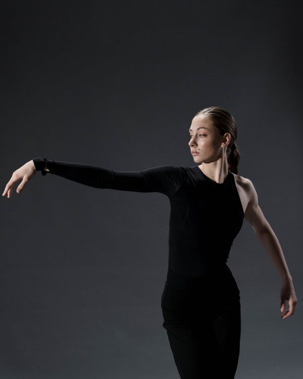 Woman performing a fluid yoga sequence in a calm setting.